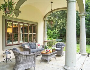 Charming outdoor loggia with cozy seating
