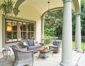 Charming outdoor loggia with cozy seating