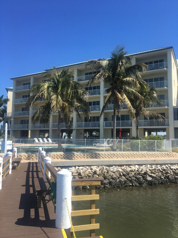 Sitting on the fishing pier outside the pool area