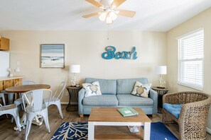 View of the living room, with queen sleeper sofa with memory foam mattress.