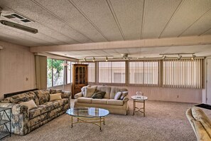 Open up a good book in the living room filled with natural light.