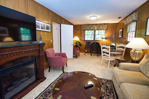 Downstairs den with 50": tv and faux fireplace