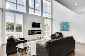 Downstairs living room with floor to ceiling windows