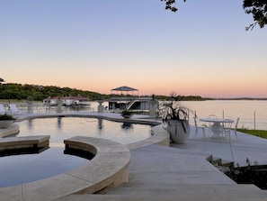 Pool and hot tub with view of the lake