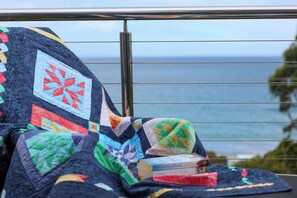 Upstairs balcony looks directly at the beach across the road