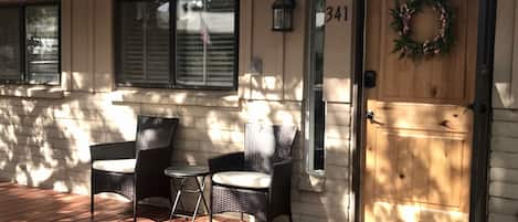 The shady deck in the front of the home.