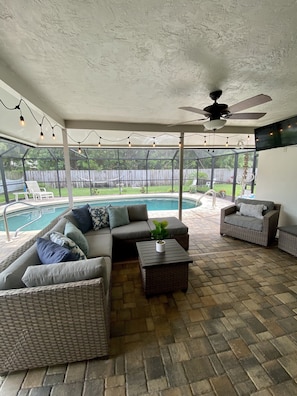 Outdoor TV on lanai and string lights for peaceful ambiance