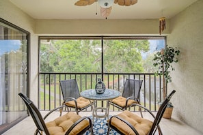 Screened porch with seating and overlooking a lake