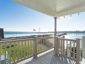 Balcony deck off dining area with view of pond and ocean