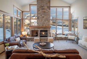 Plush living room with sweeping views of the resort, crackling fireplace, and large flat screen TV