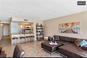 Spacious living area with counter height bar. Leather sofa to relax and sleep. 