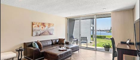 View of marina from kitchen and den. Current couch is a black sleeper sofa.