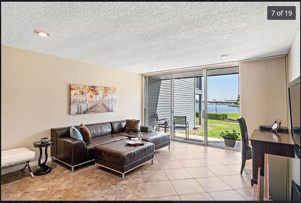 View of marina from kitchen and den. Current couch is a black sleeper sofa.