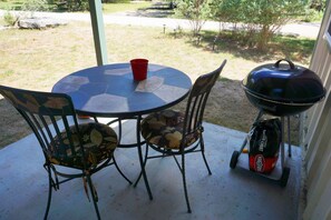 Front patio with a table and grill