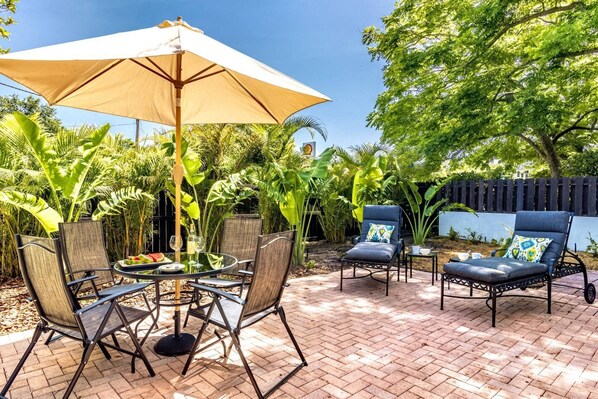 Backyard open patio with partial fencing.  Enjoy a snack or just hang out with your honey and catch some rays.