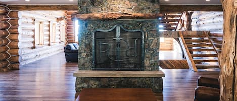Back fireplace in the Main Lodge.  Hand crafted from the local stone and logs.