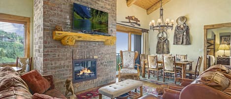 Living room with a tv and a furniture set in our Steamboat Springs vacation condo