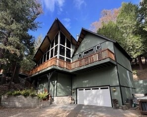 Hidden Treehouse front view with garage and decks