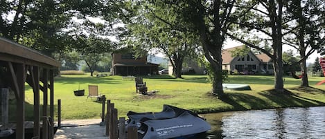 View of house from dock, large flat backyard