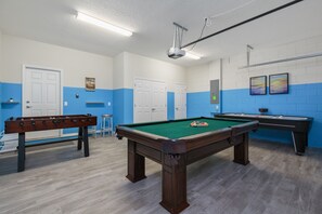 Awesome game room with foosball, air hockey, and pool tables
