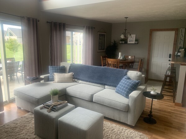 Living area featuring 65" LG TV, Bose Sounder and twin pull-out sleeper. 