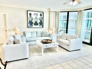 Large living room with a couch and loveseats