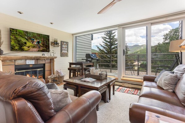 Living Room with Large Flat Screen TV and Wood Burning Fireplace!