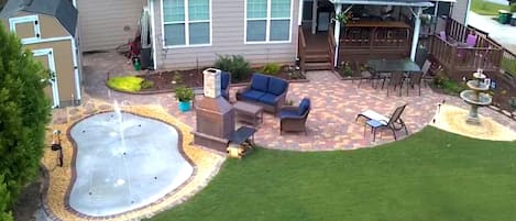 Back yard has seating for 16 and a recently added splash pad by the fireplace