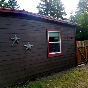 Exterior of house and parking. Entrance to the front door is through the gate.