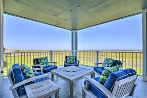 Sit on this vacation rental's covered balcony and take in the gulf view.