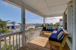 Covered deck on top level of home. 