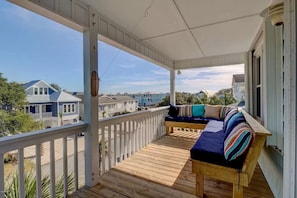 Covered deck on top level of home.