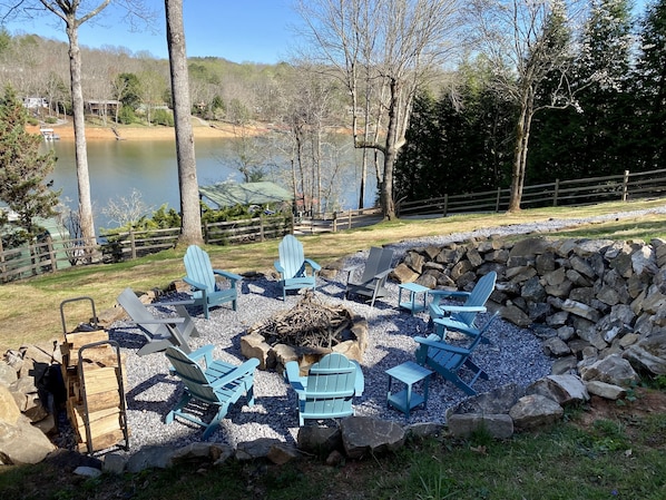 Fire pit, newly added in fenced back yard with lake views. 