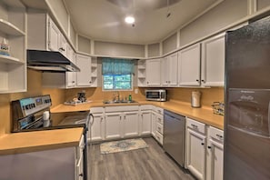 The kitchen is fully equipped with stainless steel appliances.