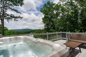 Soak in the luxurious hot tub with a glass of wine while taking in the stunning long-range mountain views!