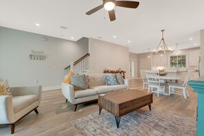 Living room with dining area (table seats 4 and 4 barstools at kitchen counter)
