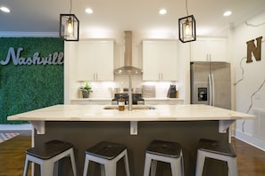 Expansive kitchen island makes entertaining easy as well as adjacent living room