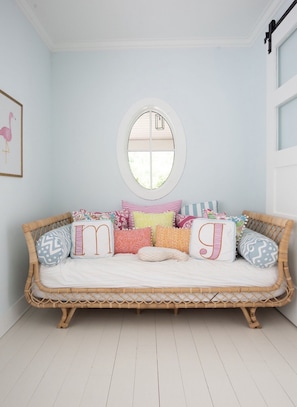 Twin daybed in playroom with cable TV