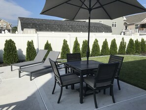 Another seating area by the pool. Stairs lead from the deck down to this patio.