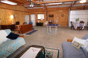 The garage has been converted to a game room with ping pong and poker table.