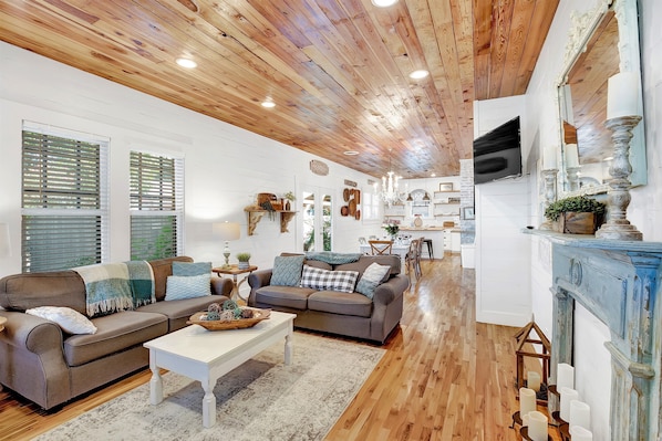 Step into the main house living room, where high detailed ceilings add a touch of unique decor.