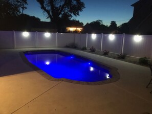 Private salt water pool at night; lighted