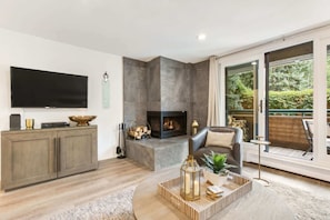 Spacious living room, with fireplace, RH king-size sleeper and heated floors. We also provide firewood for your convenience