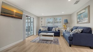 Spacious living room with seating for 5, flat panel HDTV off of the kitchen and dining room