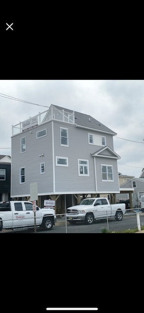 See the top floor roof deck with L-shaped lounge couch.