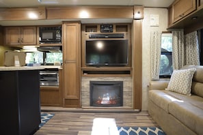 Sit Directly in front of the Warm Fireplace and Watch your Favorite Shows