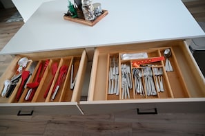 Fully stocked kitchen with lots of utensils for cooking at home