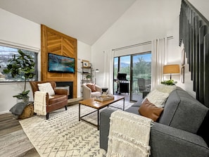 Rendezvous Condo offer a cozy living room with a gas fireplace and balcony access