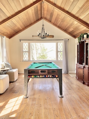 Enjoy the Great Room with its 13'  vaulted wood ceilings and pool table.