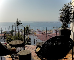 Covered balcony off the bedroom has an expansive view of the bay.